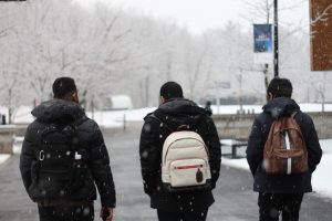 Three friends walking away from the camera